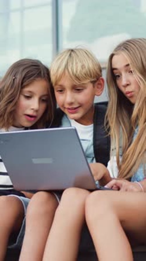 Group of Teenage School Children Using Laptop Reading Good News Celebration Rejoice Have Fun Give