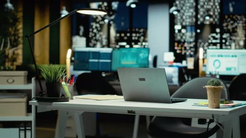 Modern Empty Office Glows with Performance Metrics and Forecasting Graphs