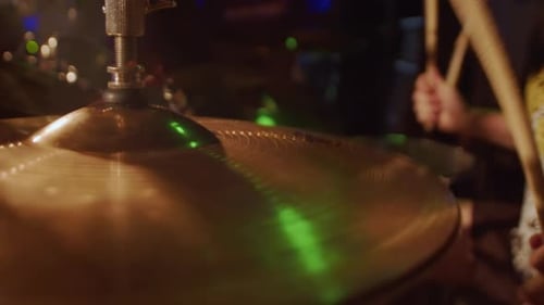 Drummer Cheerfully Playing on a Drum Set on a Stage with Concert Lighting During the Show Close Up