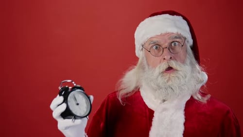Santa Claus Pointing to Midnight on Clock and Leaving with Presents