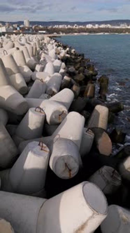 Video of Massive Concrete Tetrapod Breakwater Blocks on a Seacoast Forming a Protective Barrier