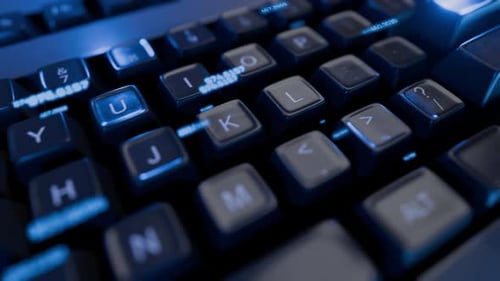 Dynamic Close-Up of Glowing Computer Keyboard with Digital Data