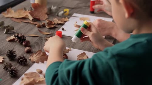 Family, Creativity and Craft Concept - Mother and Little Son with Glue
