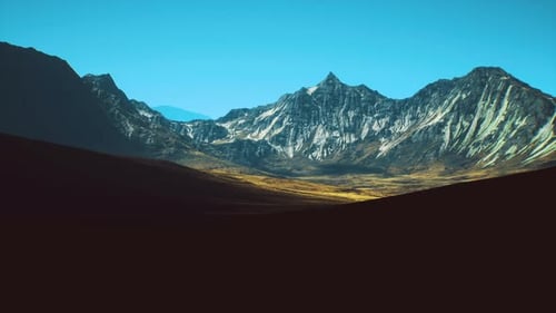 Majestic Mountain Landscape Under a Clear Blue Sky During Daylight Hours