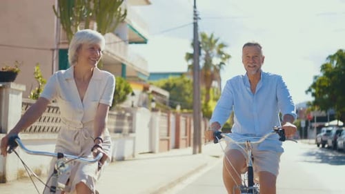 couple in love bonding outdoors and riding bicycle