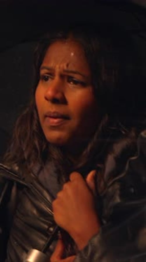 Worried Woman Under Umbrella in Rain at Night