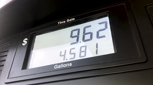 Expensive Rising Gas Prices at Pumping Station. Low Angle Close-up