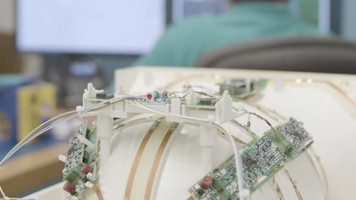 Close up slider shot of intricate circuitry and circuit boards in a piece of medical equipment