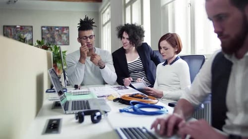 Group of Young Businesspeople Talking in Office, Start-Up Concept