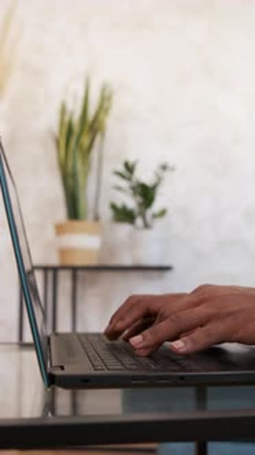 Close-up view of a man typing on laptop keyboard. Technology concept.