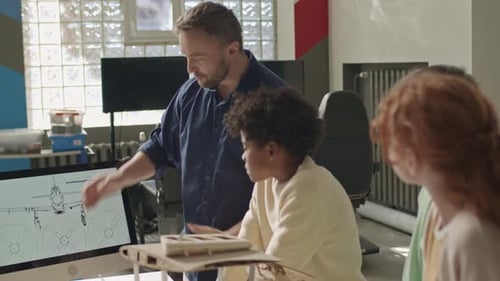 Enineering Teacher Showing Airplane Drawing Scheme to Kids