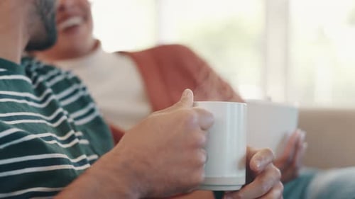 Friends Relaxing and Laughing at Home with Mugs
