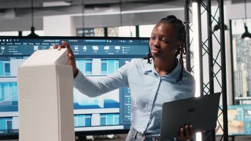Black Woman Engineer Reviews Digital Construction Blueprints for Layout