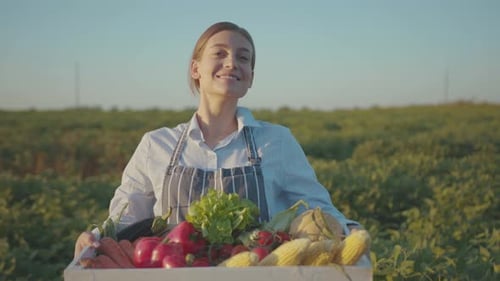 Beautiful Young Woman Look at Camera Smile Holding a Harvest of Fresh Vegetables Healthy Living