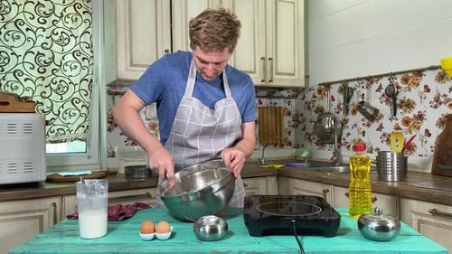 Man Mixing Ingredients in a Kitchen Bowl