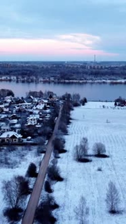 Snow covered Riga city suburbs of Katlakalns, aerial vertical view