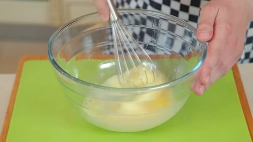 Mixing Eggs and Flour in a Glass Bowl