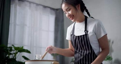 Woman Cooking Food at Home in Kitchen