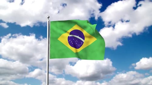 Brazilian Flag Waving Against Blue Sky and Clouds