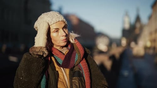 Charming Aged Lady in Warm Jacket and Scarf Standing on Street of Beautiful City Medium Portrait of