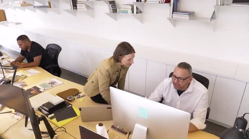 Business People Talking Working at Computer in Open Plan Office 3539 Years