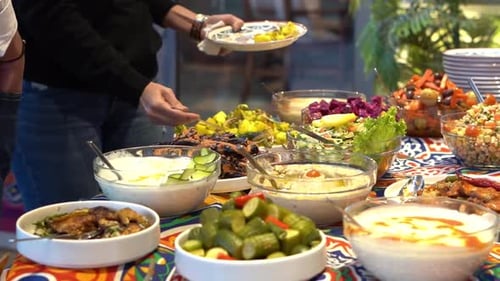 people pick their food in open buffet, close up shot