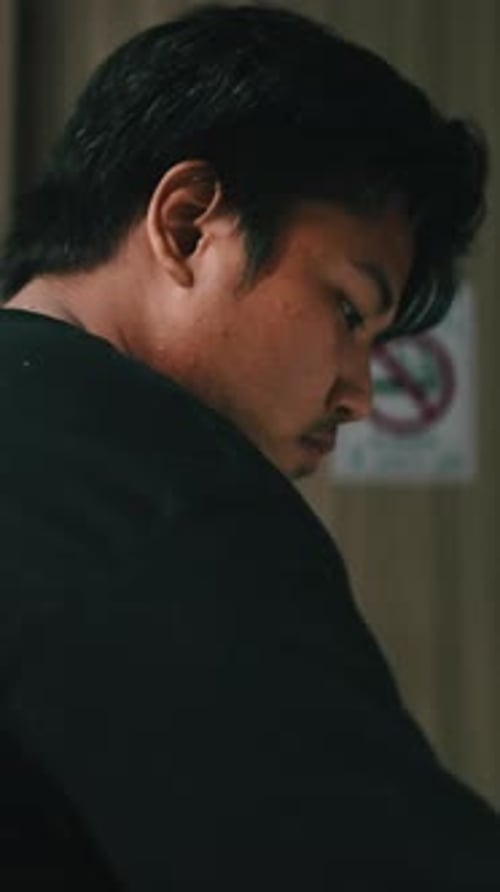 Focused Asian Chef Working in a Busy Kitchen
