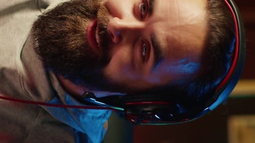 Vertical Video Close Up on Professional Gamer Streaming Game in Neon Lit Studio