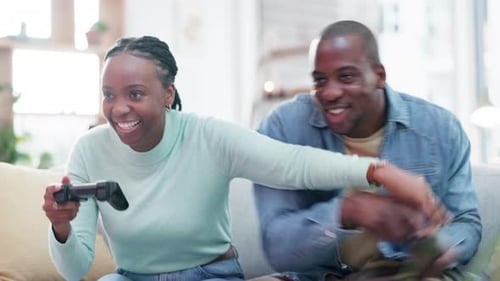 Cheerful Couple Playing Video Games at Home Together