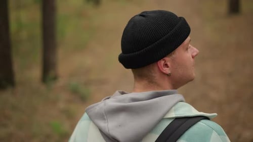 Traveler Assesses Forest Route Carefully Wanderer Surveys Wooded Pathway with Caution Explorer