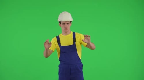 Medium Green Screen Isolated Chroma Key Video of a Young Construction Worker Swiping Tapping and