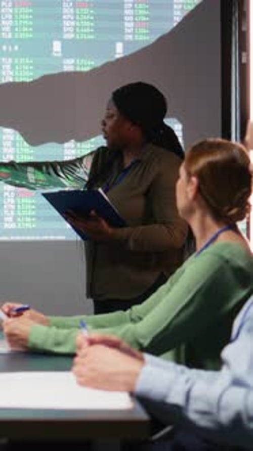 Vertical Video Diverse Executive Team Analyzing Infographics to Evaluate Supply and Demand