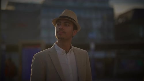 Fashionable Young Handsome Man Wearing a Hat and Casual Clothes in the City