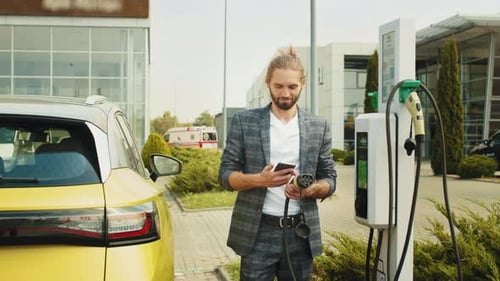 Man Charges Electric Car Using Smartphone