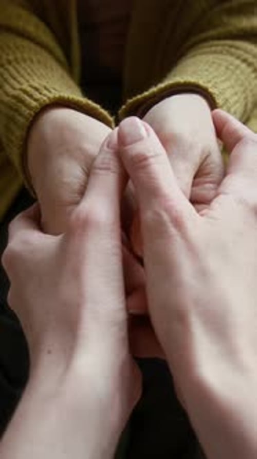 Close-Up of Woman Holding Hands of Senior Grandmother for Support