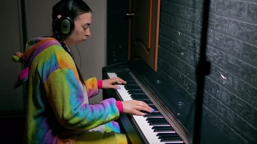 Young Adult Playing Electric Piano at Home