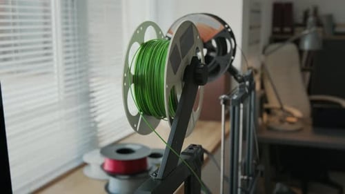 Close-up of Green Filaments on 3D Printers in Modern classroom