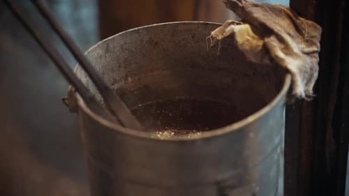 Red Hot Metal Being Quenched in Bucket