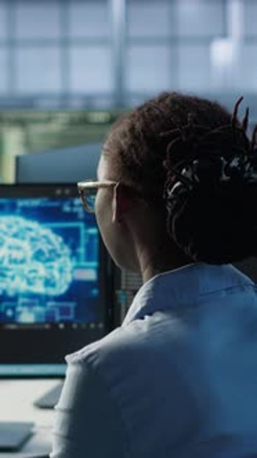 Woman Working on Computer with Brain Visualization