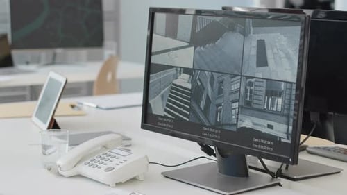 Office Security Monitors Displaying Surveillance Footage
