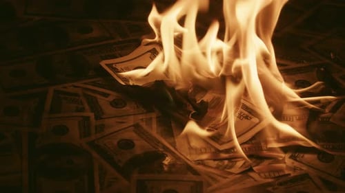 Money Burns dramatically on Dark Background