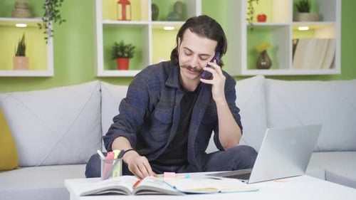 Young Adult Working at Home With Laptop