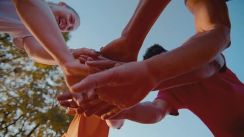 Cheerful People Gather Putting Hands Together on Street