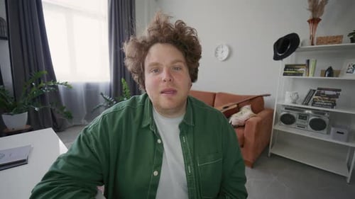 Man Waving and Speaking on Camera during Live Stream or Vlog Recording
