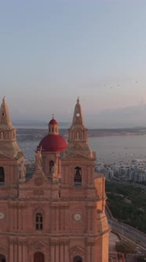 An aerial view of the Mellieha Parish Church in Malta. The iconic red dome and twin bell towers