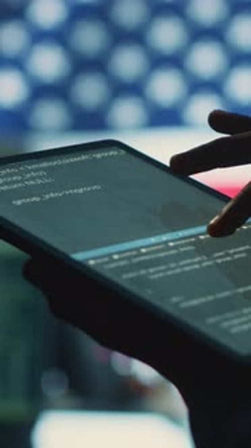 Adult Uses Tablet to View and Edit Code