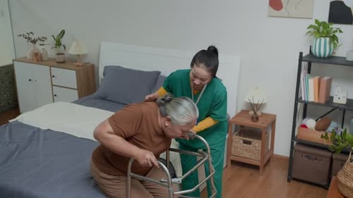 Caregiver Assists Senior Woman with Walker at Home