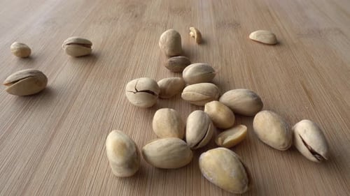 Food background. Falling Roasted pistachio nuts seed with shell close up. Dieting concept