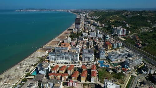 Hotels and Resorts, Summer Tourists at Durres Beach in Albania: Sandy Shores, Umbrellas, and Lounger