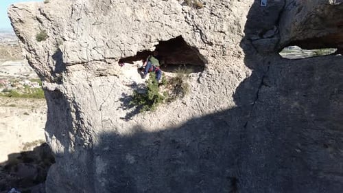 Man rock climbing aerial view of sportsman rapelling mountain in La Panocha, el Valle Murcia, Spain